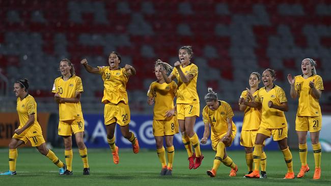 Matildas players celebrate the win.