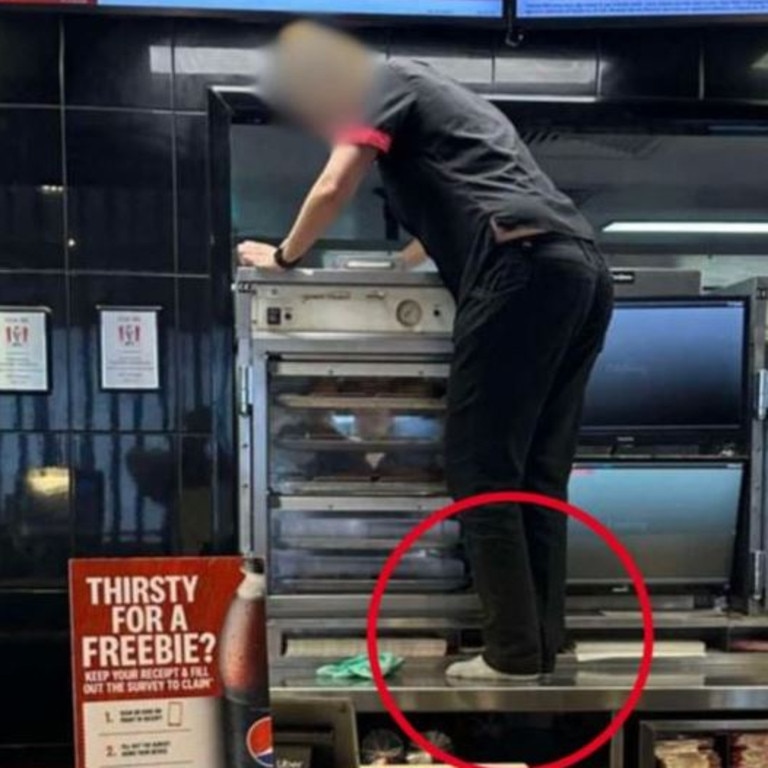 A KFC employee has been spotted standing on the counter without shoes. Picture: 7News