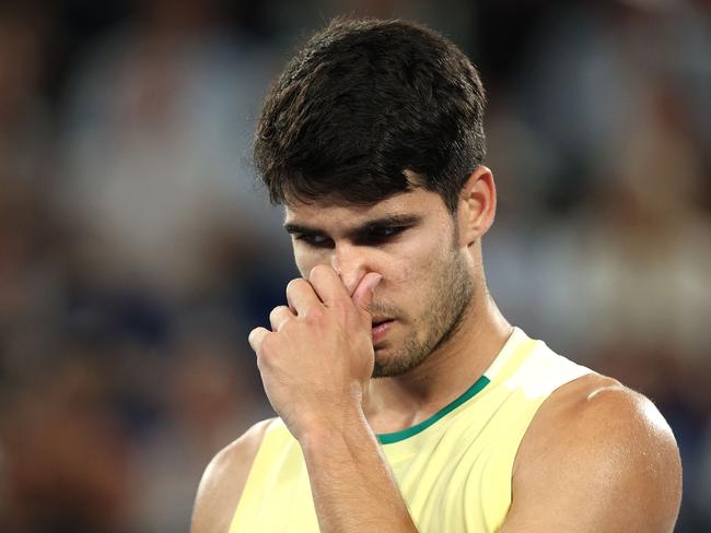 Spain's Carlos Alcaraz reacts as he plays against Germany's Alexander Zverev during their men's singles quarter-final match on day 11 of the Australian Open tennis tournament in Melbourne on January 24, 2024. (Photo by Martin KEEP / AFP) / -- IMAGE RESTRICTED TO EDITORIAL USE - STRICTLY NO COMMERCIAL USE --