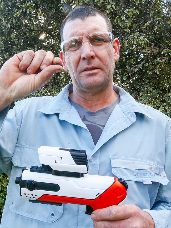 Launceston Gel Ball Club president Roger Lutwyche with a hand blaster and a gel round. Picture: PATRICK GEE