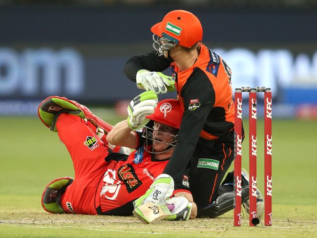 Cameron Bancroft of the Scorchers and Sam Harper of the Renegades tangle at the crease. Picture: Getty Images