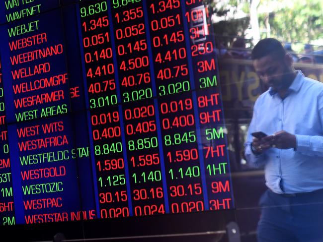 A man is reflected in the window as he walks past the Australian Securities Exchange (ASX) in Sydney, Tuesday, February 6, 2018. The Australian share market has suffered its biggest one-day fall in more than two years, wiping around $66 billion from its value. (AAP Image/David Moir) NO ARCHIVING