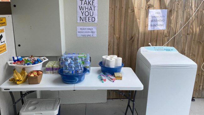 The Clayfield collection point for donated food, and the community washing machine.