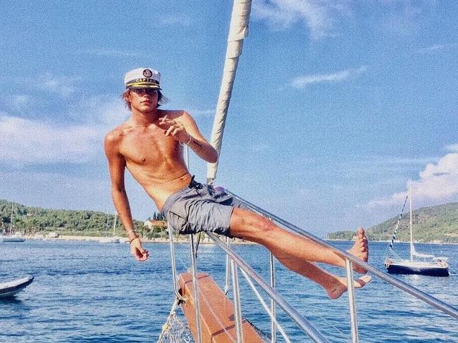 Jordan Barrett does his daily workout hanging from a yacht with a ciggie in his hand... 