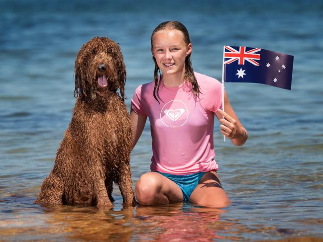 Arabella, 12, and Max the dog cool off in the water. Picture: Tony Gough