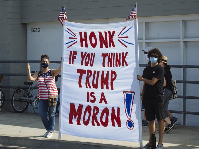 Summer Bailey (Left) holds a sign reading 