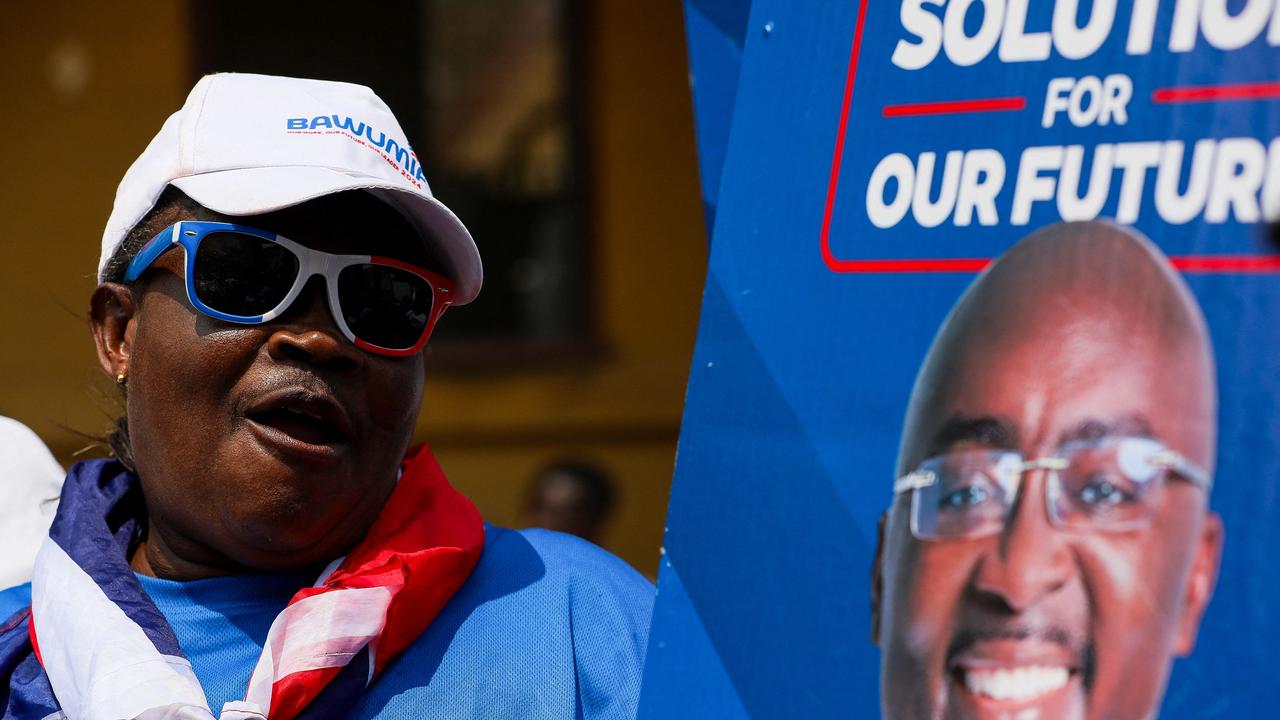 A supporter holds a placard depicting the portrait of Mahamudu Bawumia, Vice President of Ghana. Picture: Nipah Dennis/AFP