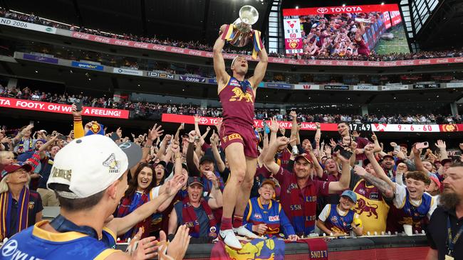 Lions Josh Dunkley celebrates with fans after Brisbane win the AFL Grand Final. Picture Lachie Millard