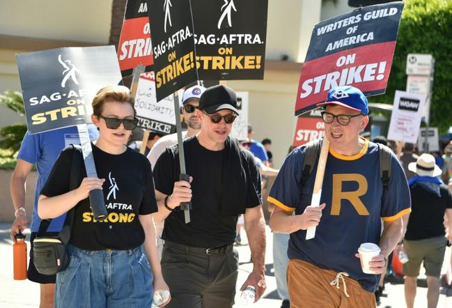 US actress Ginnifer Goodwin (L) joins members of the Writers Guild of America and the Screen Actors Guild as they walk a picket line outside of Paramount Pictures studios in Los Angeles