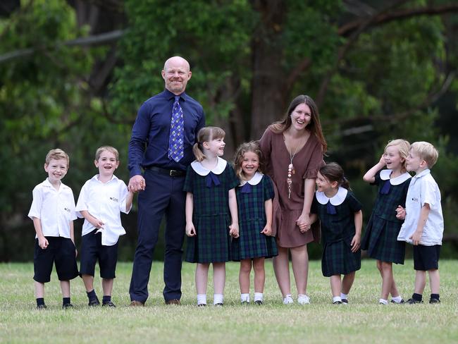 Coast Christian School Principal Matthew Drennan pictured Thursday 17th March 2022 with Kindergarten teacher Georgina Battle who also taught in Kindy many years ago and kindy kids Tyler King,Oliver Lendrum,Lola Robertson,Vivienne CarneyClementine Stucken,Lilly Jones and Morgan Smith .pic Sue Graham