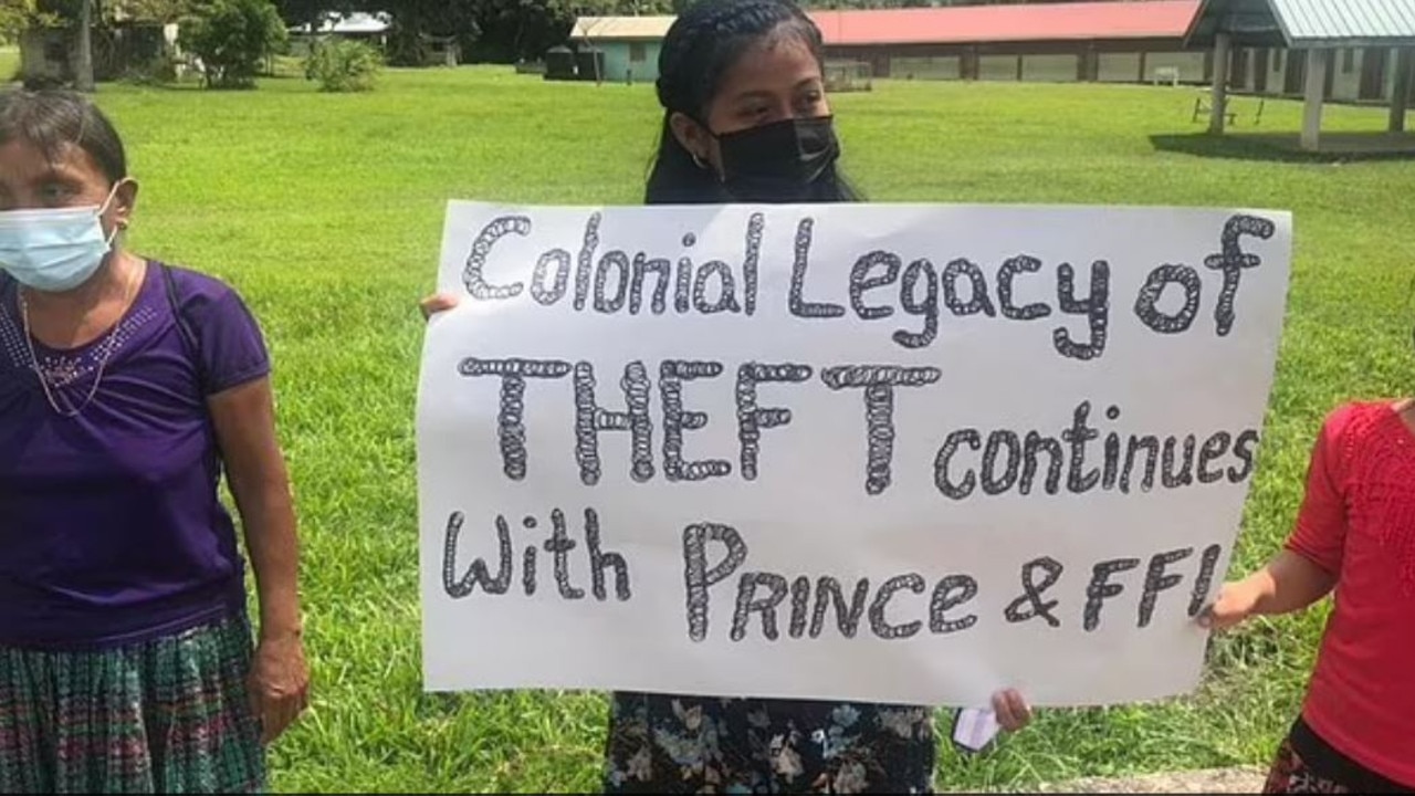 This villager carried a sign with the words “colonial legacy of theft continues with Prince &amp; FFI. Picture: Supplied