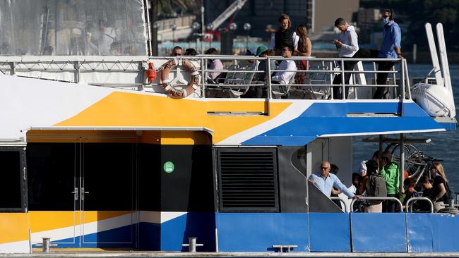 SYDNEY, AUSTRALIA - NewsWire Photos MARCH 4, 2021: Morning commuters some pictured in masks some withouts masks heading towards Circular Quay on the Manly fast ferry.Picture: NCA NewsWire / Damian Shaw