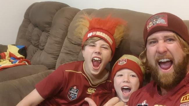 Nathan Vogel settles in for state of Origin with sons Travin, left, and Harley. Mr Vogel died in hospital after falling off his bicycle when riding home in Burleigh last weekend