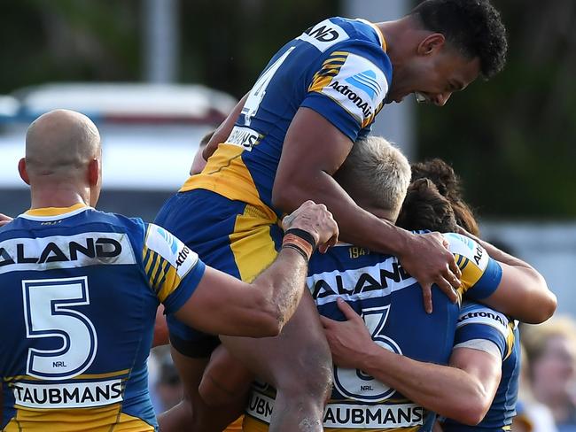 ROCKHAMPTON, AUSTRALIA - SEPTEMBER 12: Waqa Blake of the Eels jumps in his team mates as Mitchell Moses of the Eels celebrates with his team mates after scoring a try during the NRL Elimination Final match between Parramatta Eels and Newcastle Knights at Browne Park, on September 12, 2021, in Rockhampton, Australia. (Photo by Albert Perez/Getty Images)