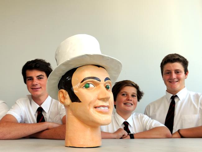 St Paul's Manly students (from left) Josh Cotton, 15; William Sim, 15, and; Angus Armstrong, 16, helped paint Manly's iconic ‘Tyre Man's’ head.