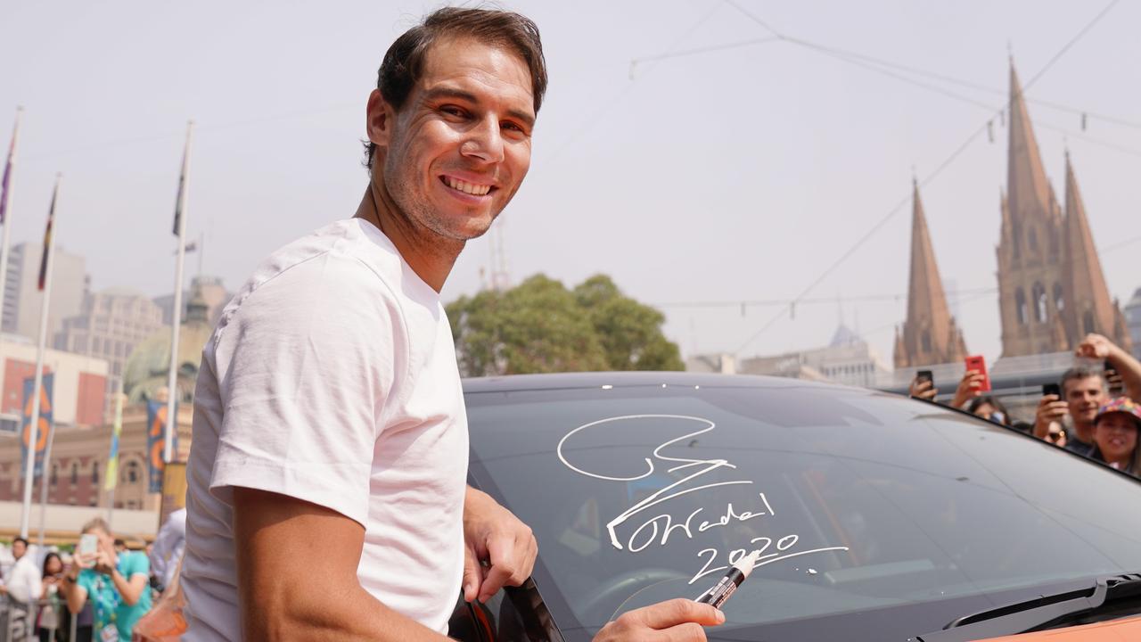 Raphael Nadal at an event in Melbourne on Wednesday. Smoke haze can be seen in the background, which Australian Open qualifiers had to play through. (AAP Image/Michael Dodge)