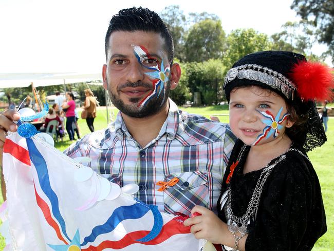 Ninos Yeoukar and Ashurita with the Assyrian flag at celebrations organised by Settlement Services International in Auburn.