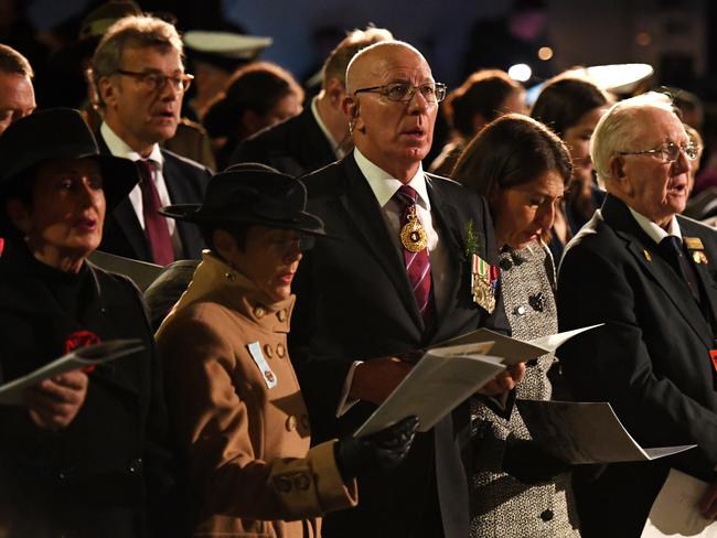 NSW Governor David Hurley (centre), his wife Linda Hurley (centre, left) and NSW Premier Gladys Berejiklian (centre, right), sing a hymn at the Anzac Day dawn service at Martin Place. Picture: AAP