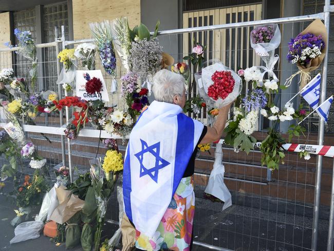 MELBOURNE, AUSTRALIA - NewsWire Photos DECEMBER 08, 2024: People gather for a vigil near the Adass Israel Synagogue of Melbourne after it was destroyed by fire on Friday. Picture: NewsWire / Andrew Henshaw