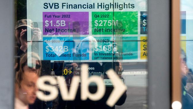 A display lists Silicon Valley Bank (SVB) achievements as customers gather to withdraw money at the bank’s headquarters in Santa Clara, California. Picture: AFP.