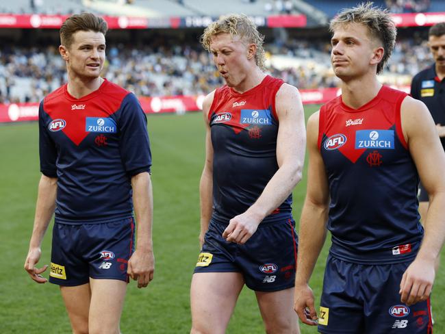 Oliver walks off with Harry Sharp and Bayley Fritsch. Picture: Michael Klein