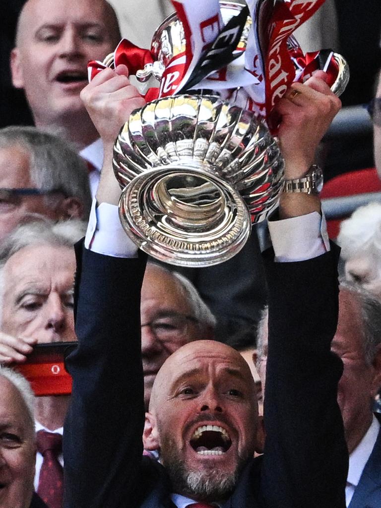 Erik ten Hag lifts the FA Cup trophy. (Photo by JUSTIN TALLIS / AFP)