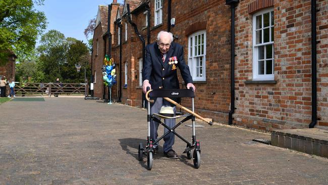 Capt Moore with his walking frame doing a lap of his garden in the village of Marston Moretaine, 80km north of London. Picture: AFP