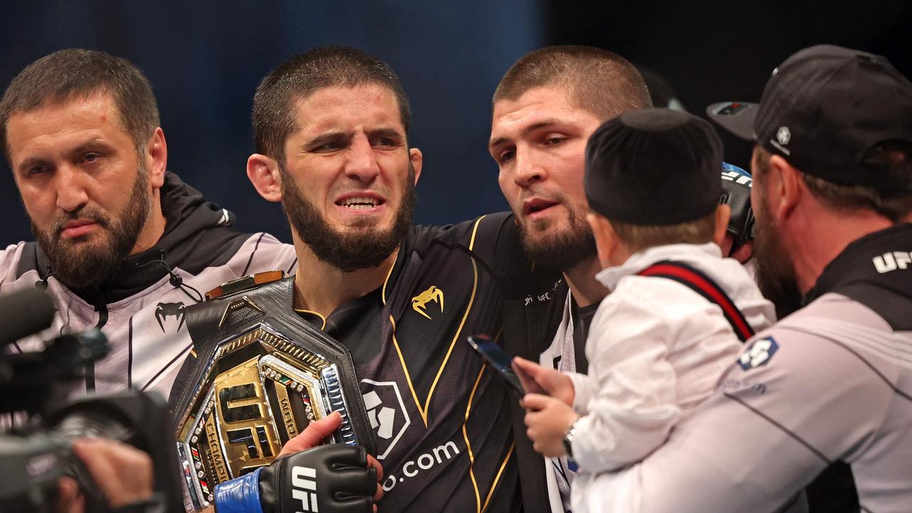 Islam Makhachev celebrates with his team after defeating Charles Oliveira. (Photo by Giuseppe CACACE / AFP)