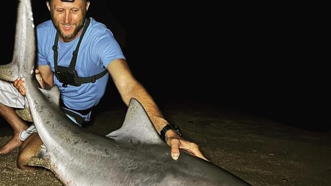 Luke Anstiss with the bull shark caught in the Noosa River. Photo: Contributed