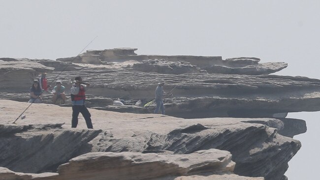 Rock fishers at Voodoo Point after the situation unfolded. Picture: John Grainger