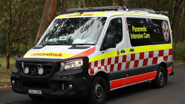 SYDNEY, AUSTRALIA - NewsWire Photos JANUARY 20, 2021: An ambulance passes by a police road block near Keith Longhurst Reserve near where a police search is underway on the Georges river for a 15-year-old teenage boy believed to have drowned while swimming.Picture: NCA NewsWire / Damian Shaw