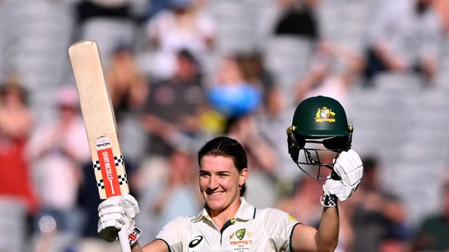 Australia's Annabel Sutherland celebrates scoring her century during the second day of the Women's Ashes cricket Test match between Australia and England at the Melbourne Cricket Ground (MCG) in Melbourne on January 31, 2025. (Photo by William WEST / AFP) / --IMAGE RESTRICTED TO EDITORIAL USE - STRICTLY NO COMMERCIAL USE--