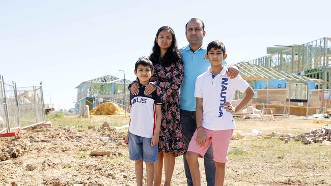 Vishu Moondra, his wife Aditi Gupta and their sons (from left) Aariv, 7, and Vivaan, 11, on their block of land in Rouse Hill. Picture: Tim Hunter