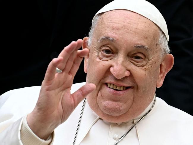 (FILES) Pope Francis waves as he arrives to attend the unveil of a new electric popemobile, at the Vatican on December 4, 2024. Pope Francis passed a 