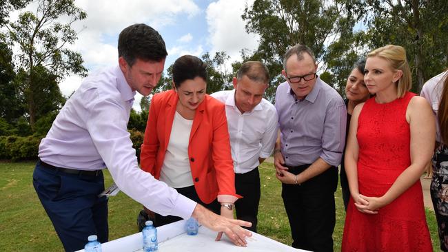 Queensland Labor Main Roads Minister Mark Bailey outlines plans for M1 upgrades with Premier Palaszczuk at Oxenford on the Gold Coast during the Queensland Election campaign yesterday. (AAP Image/Darren England)