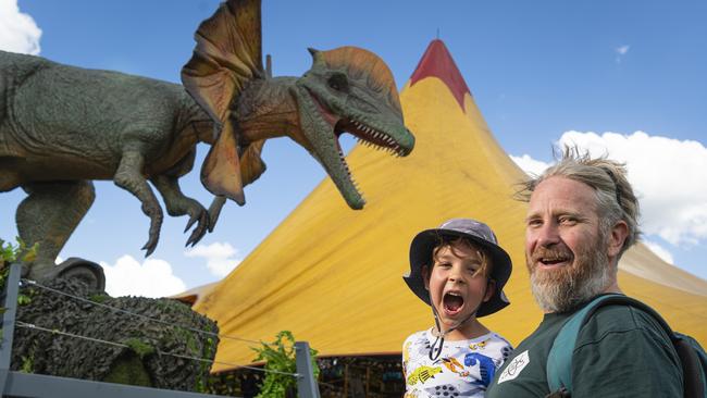 Tim (left) and Lockwood Allmand check out the Jurassic Creatures dinosaur exhibit in Toowoomba's Queens Park, Thursday, January 16, 2025. Picture: Kevin Farmer