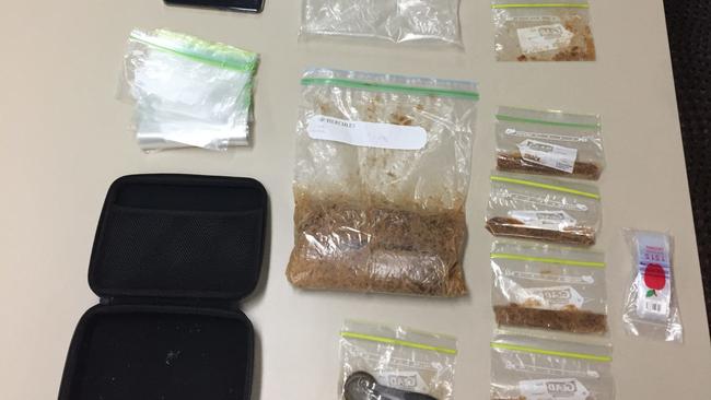 Drugs and items uncovered during a police search in Airlie Beach on Thursday. Police allege more than 1kg of MDMA was uncovered.