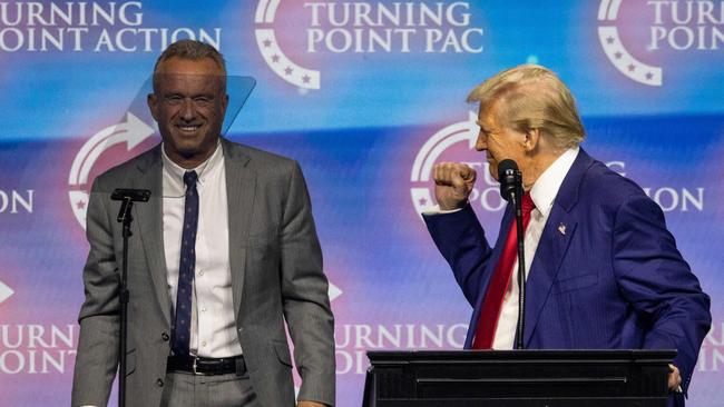 Donald Trump raises a fist as he brings Robert F. Kennedy onto the stage during a campaign rally at the Gas South Arena in Duluth, Georgia, in October. Picture: AFP