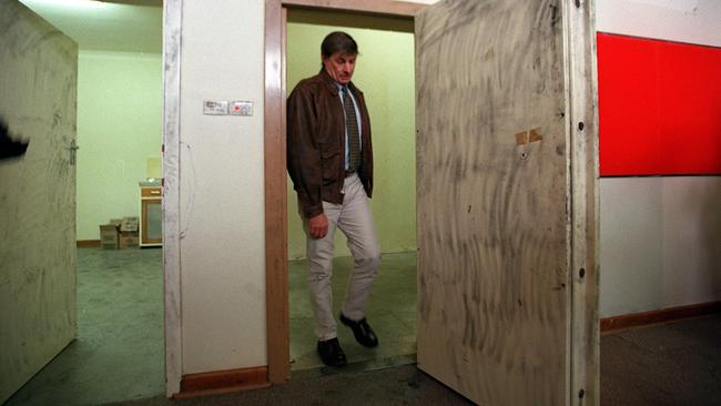 Police officer Denis Edmond inside the bank vault shortly after the barrels were discovered.