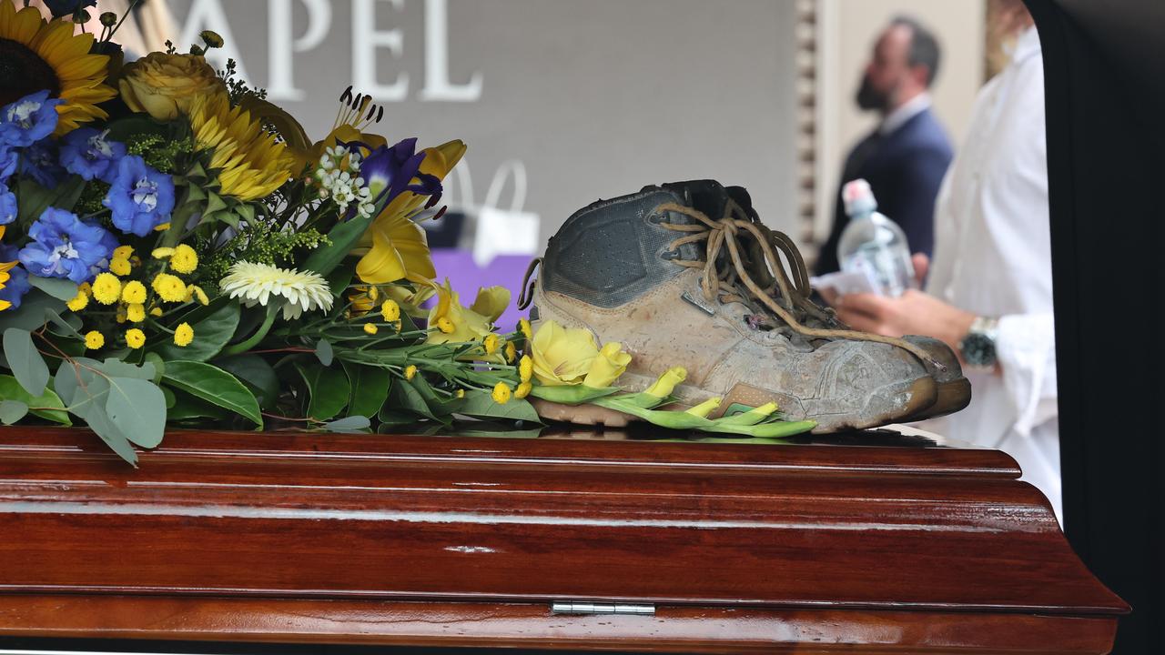 Cameron’s work boots and a number of fishing rods were present at his funeral to reflect elements of his life. Picture: Glenn Hampson