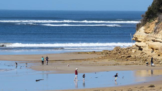 People enjoy some morning sun at Fisherman's Beach in Torquay. Picture: Alison Wynd