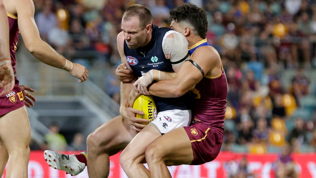 Sam Docherty is tackled by Cam Rayner at the Gabba. Picture Russell Freeman/AFL Photos via Getty Images