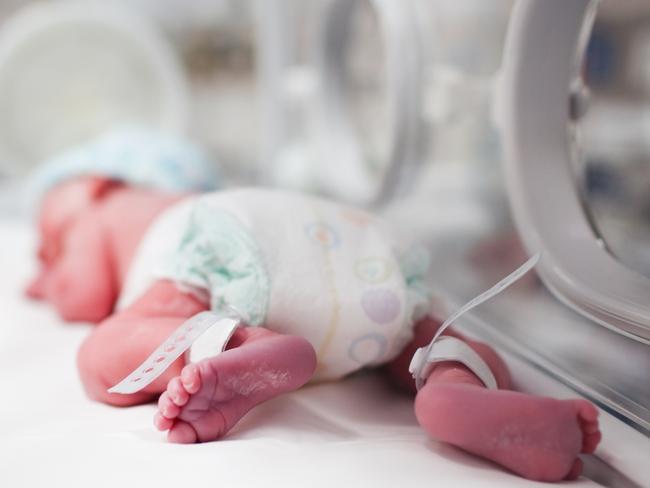 Newborn baby boy covered in vertix inside incubator. iStock Image - Generic