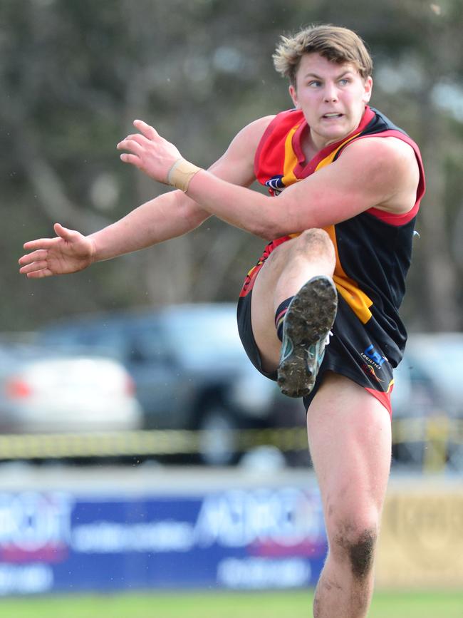 Tom Atkins kicks long in Joeys colours in an under-18 game.