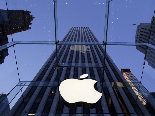 FILE - In this Sept. 5, 2014 file photo, the Apple logo hangs in the glass box entrance to the company's Fifth Avenue store, in New York. Apple, already the world's most valuable company, surpassed $700 billion in market capitalization Tuesday, Nov. 26, 2014, as its stock hit another all-time high. (AP Photo/Mark Lennihan, File)