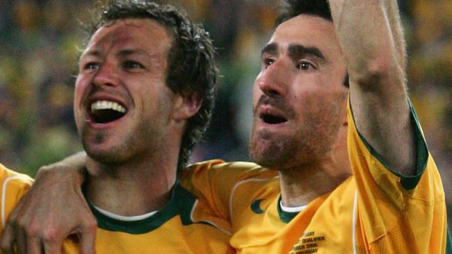 SYDNEY, NSW - NOVEMBER 16:  Lucas Neill #2 and Tony Vidmar #5 for the Socceroos celebrates after winning the second leg of the 2006 FIFA World Cup qualifying match between Australia and Uruguay at Telstra Stadium November 16, 2005 in Sydney, Australia.  (Photo by Robert Cianflone/Getty Images)