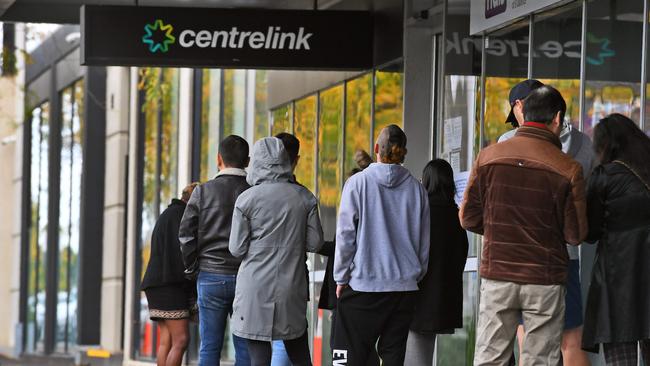 People queue up outside a Centrelink office. The Morrison Government is considering the next phase of Jobseeker payments after the coronavirus supplement ends in September. Picture: William West/AFP