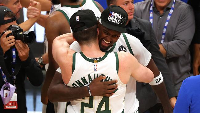 Bobby Portis of the Milwaukee Bucks hugs Pat Connaughton.