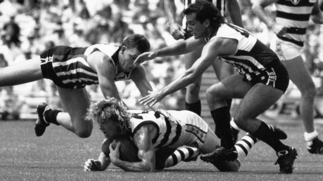 Geelong’s Garry Hocking (ground) is swamped by Port Adelaide’s Bruce Abernethy and George Fiacchi during a pre-season match in February, 1990. Picture: Phil Hillyard