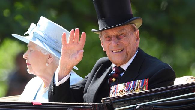 Queen Elizabeth II and Prince Philip, Duke of Edinburgh ride by carriage during the annual Trooping The Colour parade at the Mall in 2017.